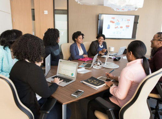 Group of Women Sitting Around a Conference Table
